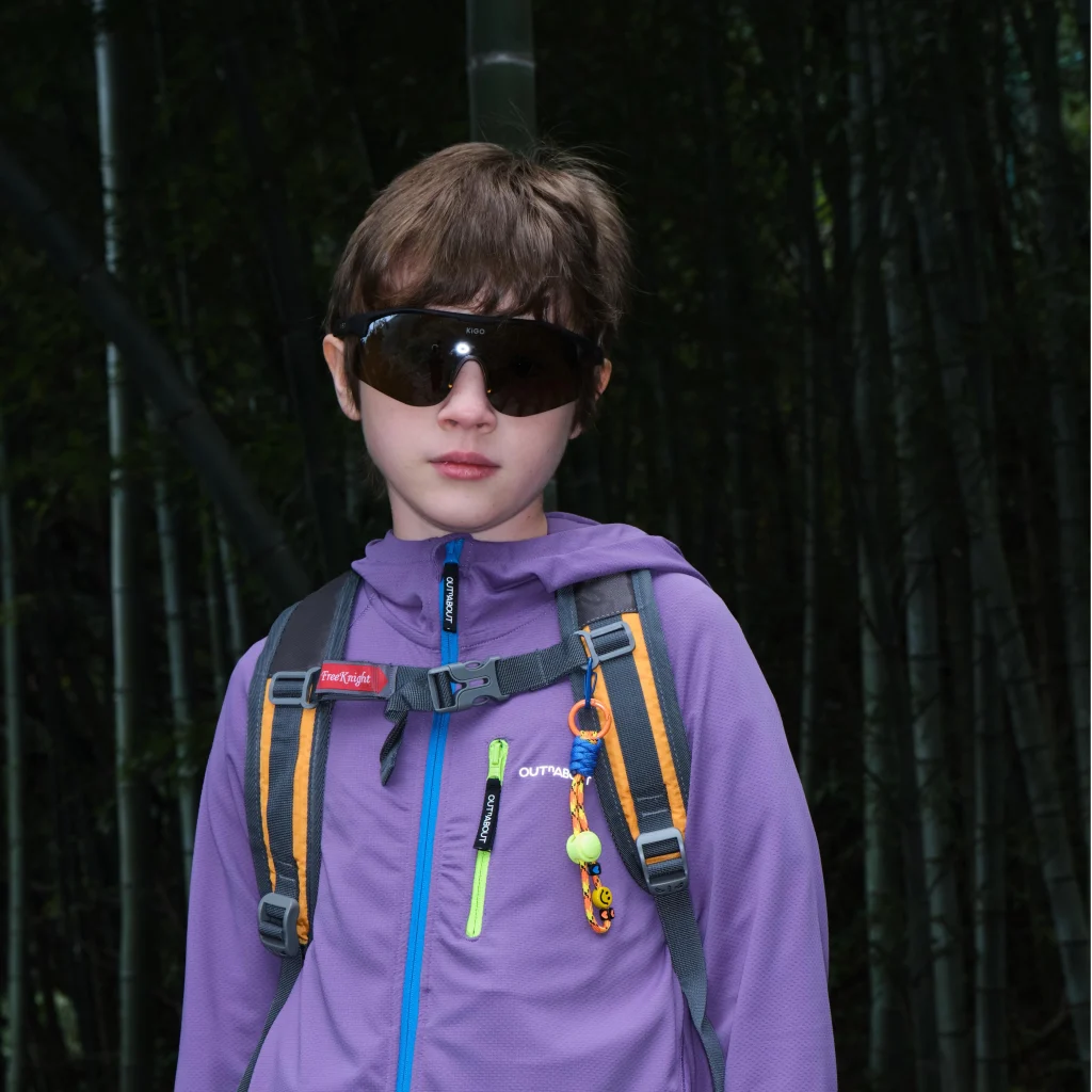 Cool kid in KiGO sunglasses in the mountain forest