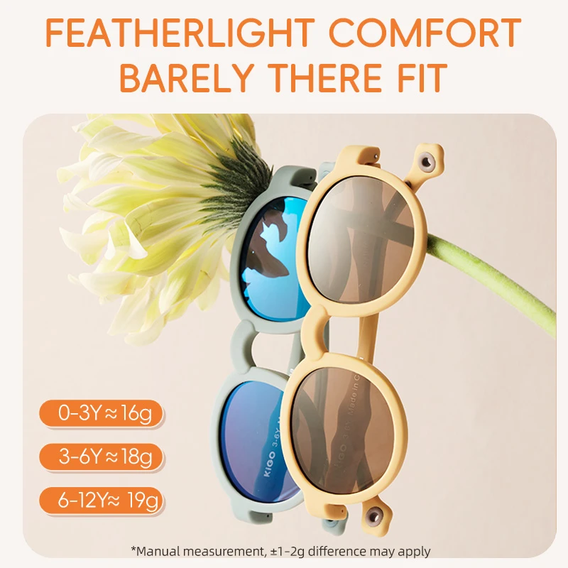 KIGO California sunglasses beach kids displayed with a yellow flower, emphasizing "FEATHERLIGHT COMFORT BARELY THERE FIT". Weight details: 0-3Y ≈16g, 3-6Y ≈18g, 6-12Y≈19g (with a note on manual measurement variance).