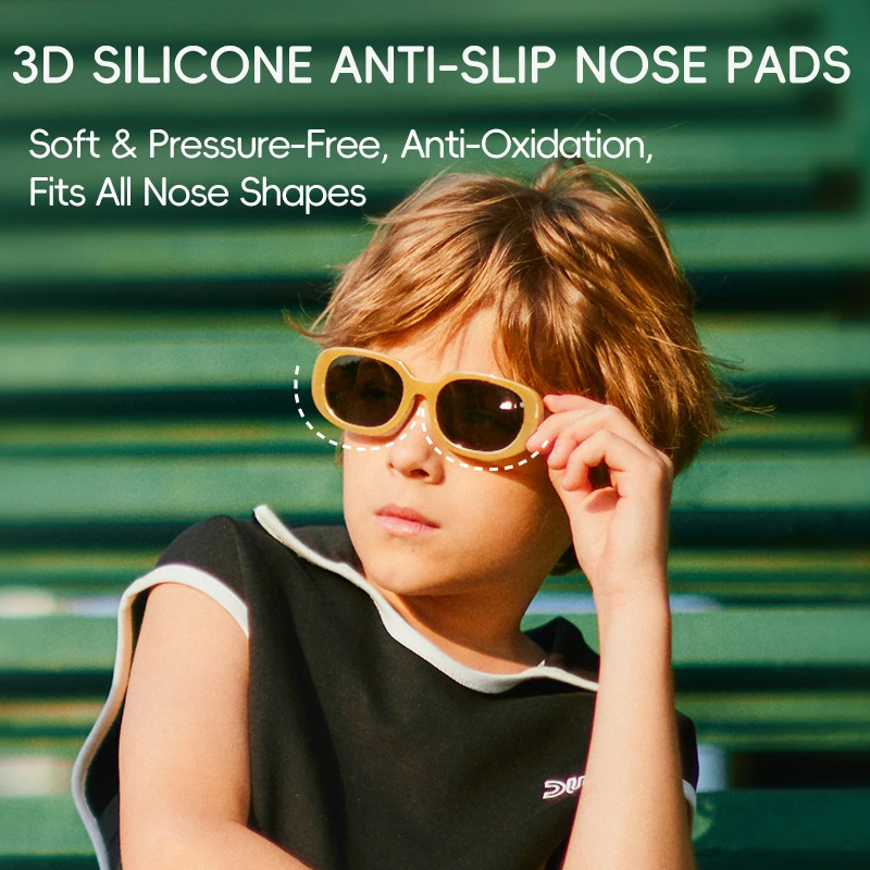 A child adjusting KIGO California sunglasses with 3D silicone anti - slip nose pads. The background is green. Text describes "3D SILICONE ANTI-SLIP NOSE PADS" as "Soft & Pressure-Free, Anti-Oxidation, Fits All Nose Shapes".