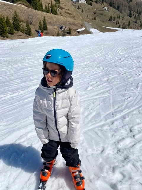 A boy skiing with black KiGo polarized sunglasses