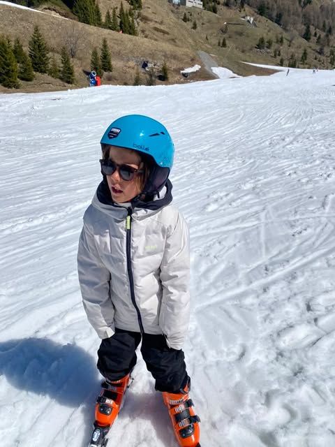 A boy skiing with black KiGo polarized sunglasses