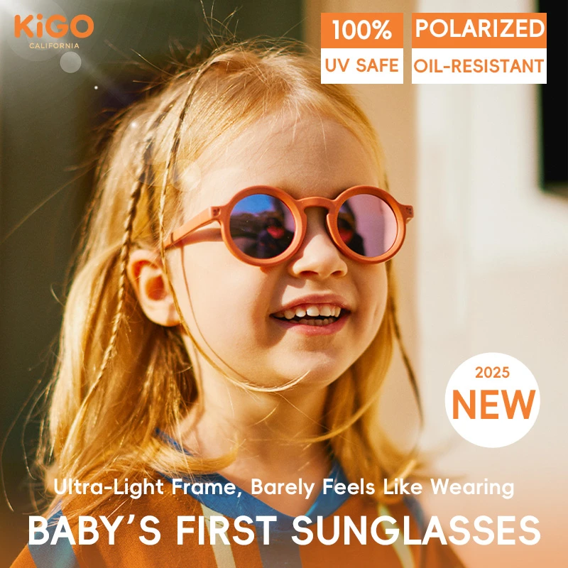 A girl wearing KIGO California's 2025 new baby's first sunglasses for 0-2 years with an ultra-light frame. Text highlights "100% UV SAFE", "POLARIZED OIL-RESISTANT", and "Ultra-Light Frame, Barely Feels Like Wearing", with the brand logo in the top left.