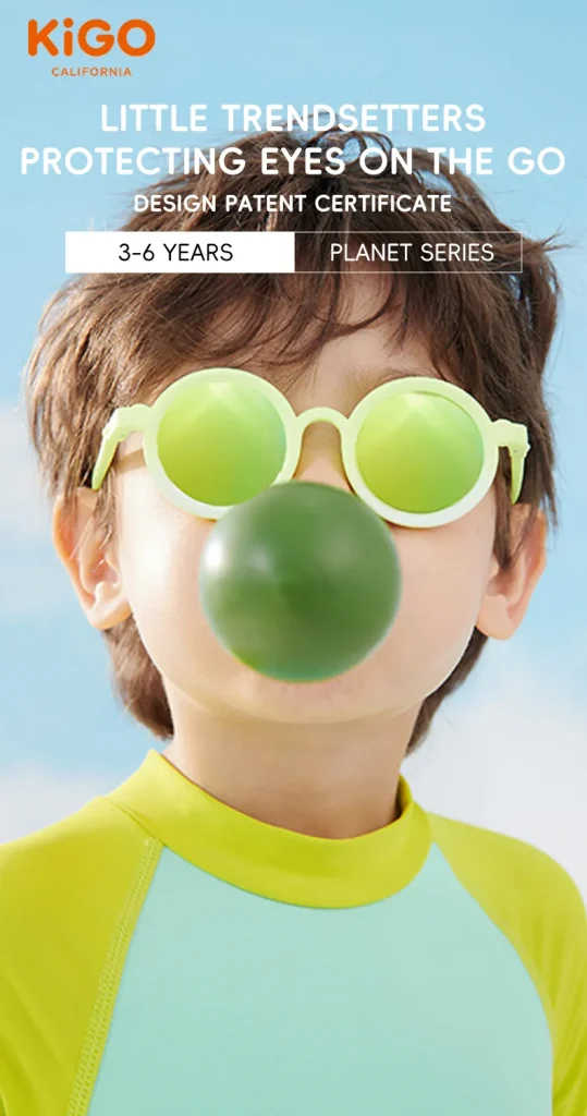 A boy wearing sunnies sunglasses​ blows a bubble..