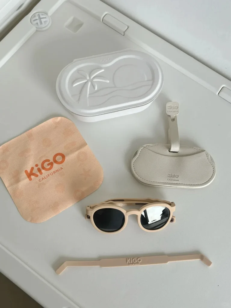 Best brand for kids sunglasses KiGO California 0-3 years old product gift package. It includes a pair of glasses, a glasses cloth, a glasses strap, a glasses bag for easy storage and a box that can hold the above items.